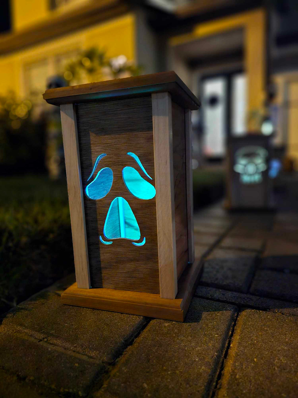 Wooden lantern face showing a moaning ghost face.