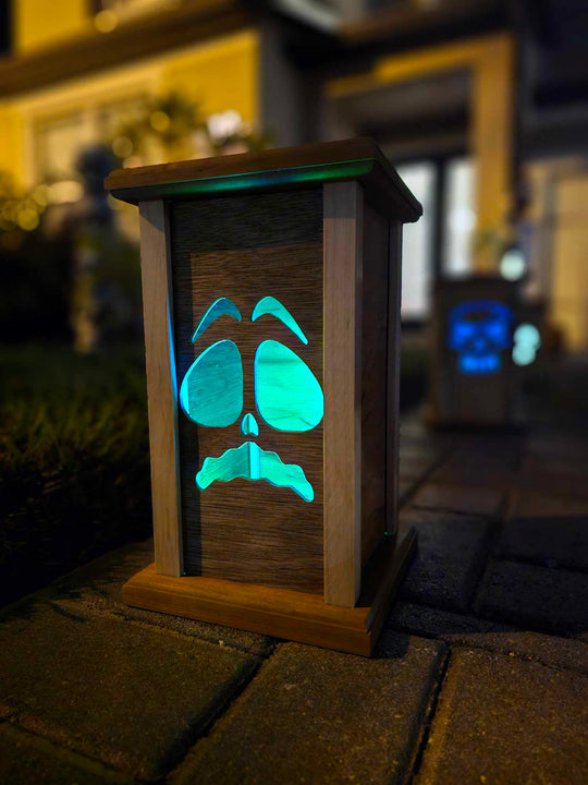 Wooden lantern face showing a scared ghost face.
