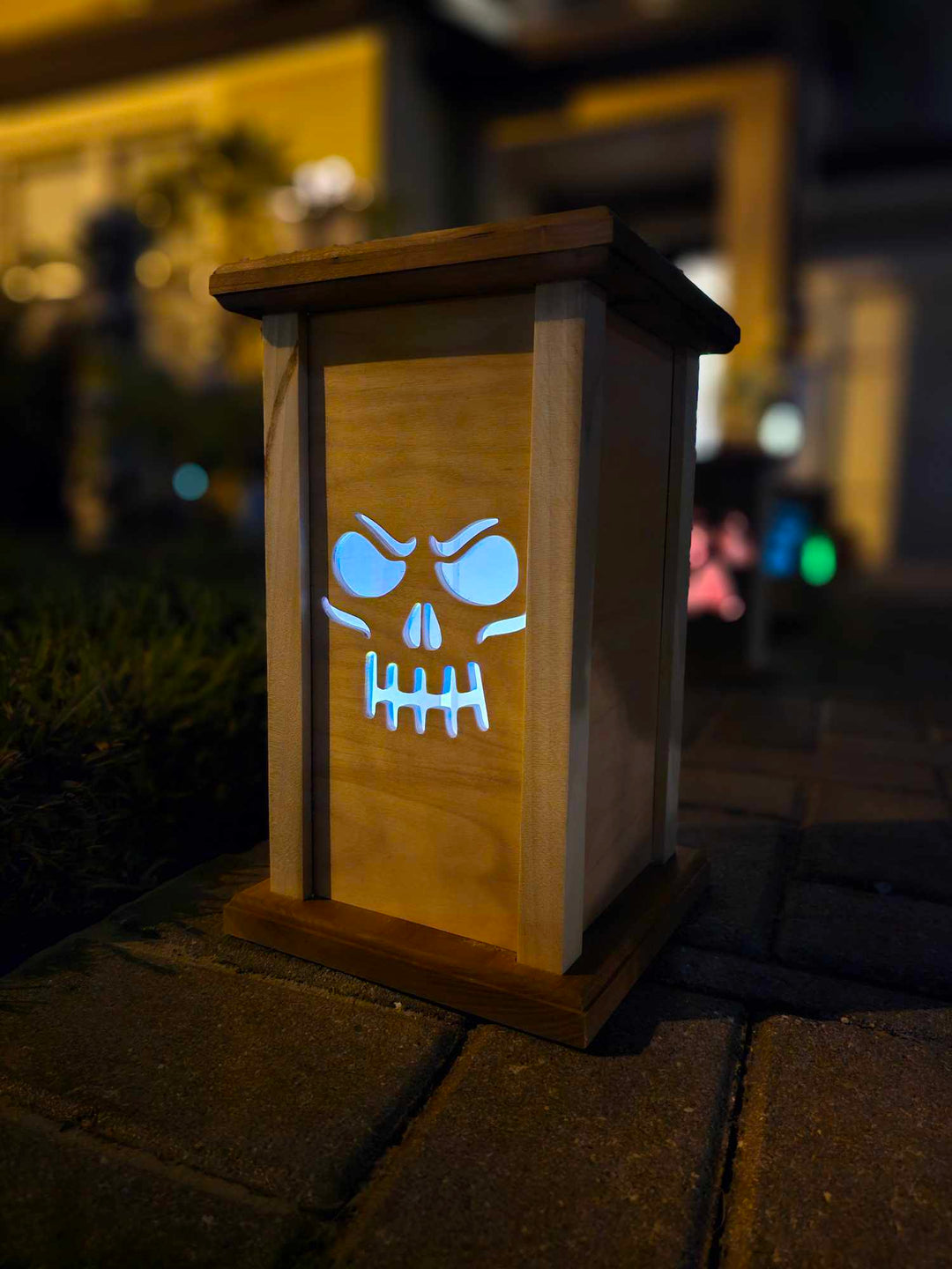 Wooden Lantern face depicting a grinning skull face.