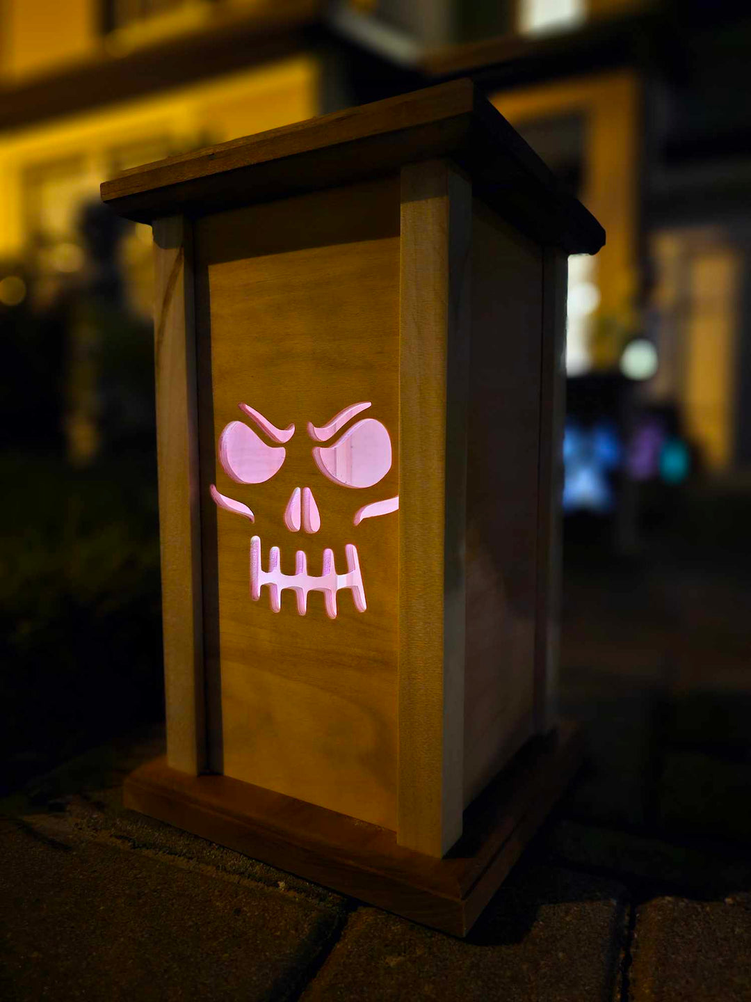 Wooden Lantern face depicting a grinning skull face.