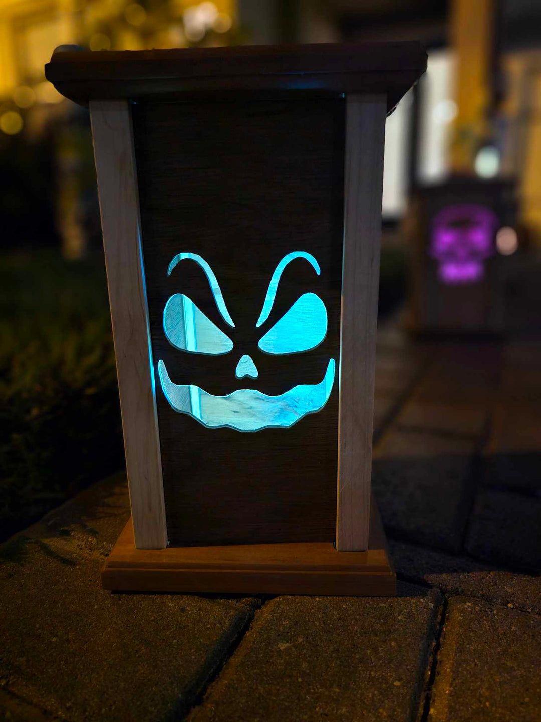 Wooden lantern face showing sinister smiling ghost.