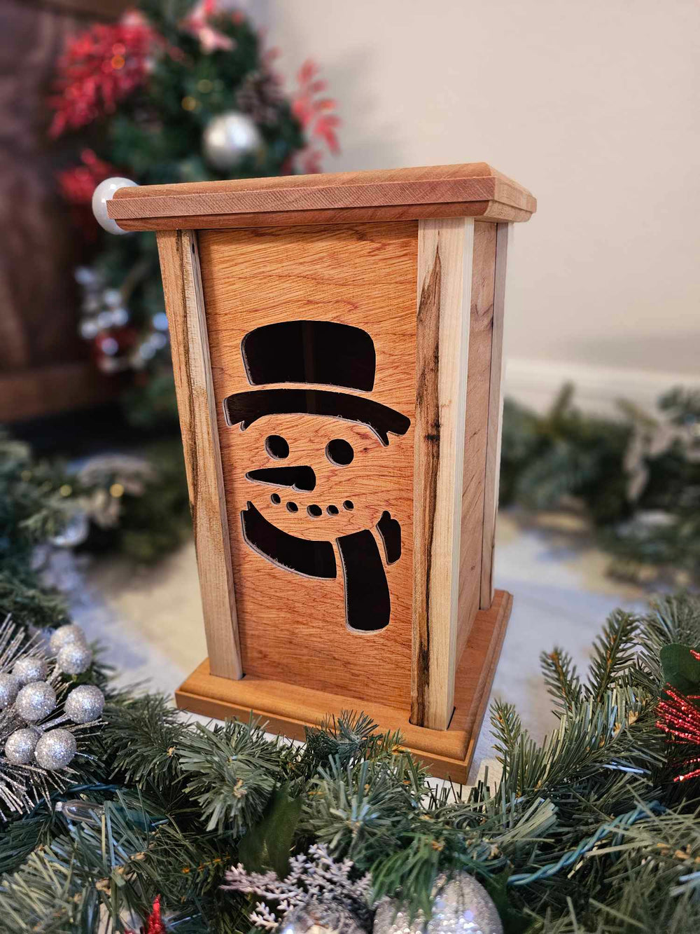 Wooden Lantern face depicting a snowman.
