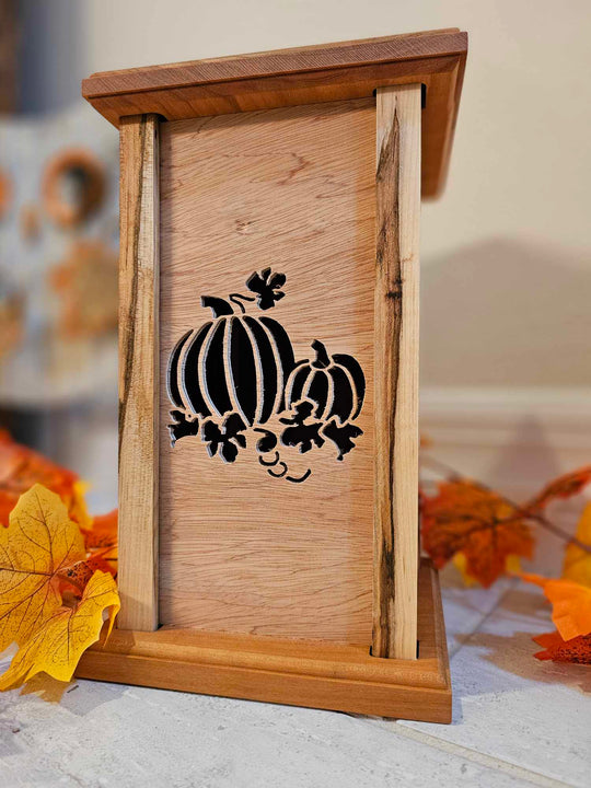 Wooden lantern face showing two pumpkins.