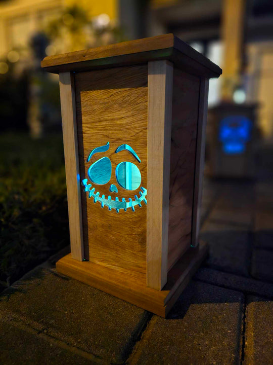 Wooden lantern face with grinning ghost face.