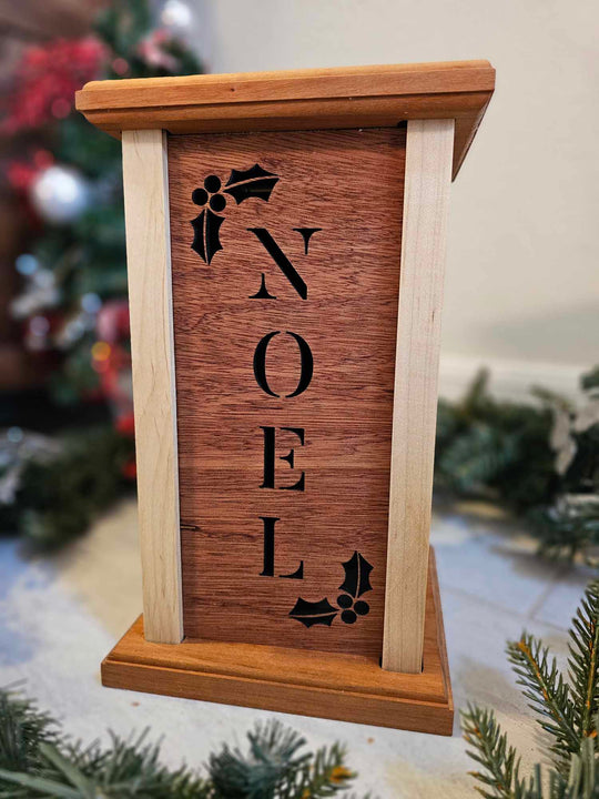 Wooden Lantern face with holly and the word Noel.
