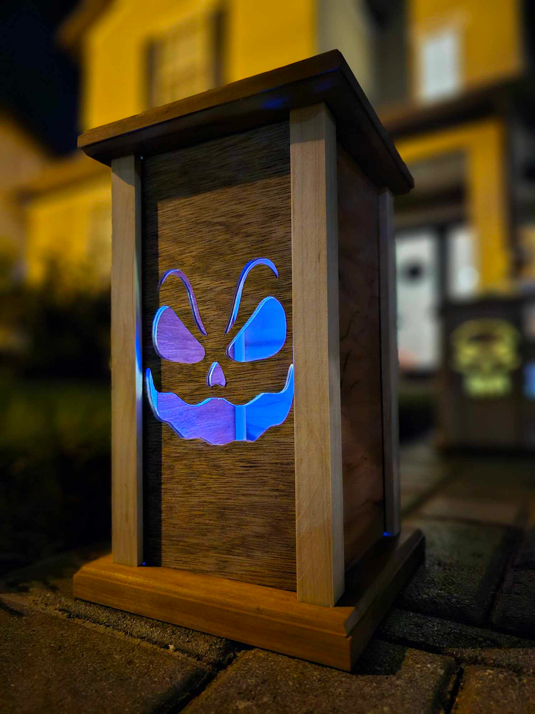 Wooden lantern face showing sinister smiling ghost.