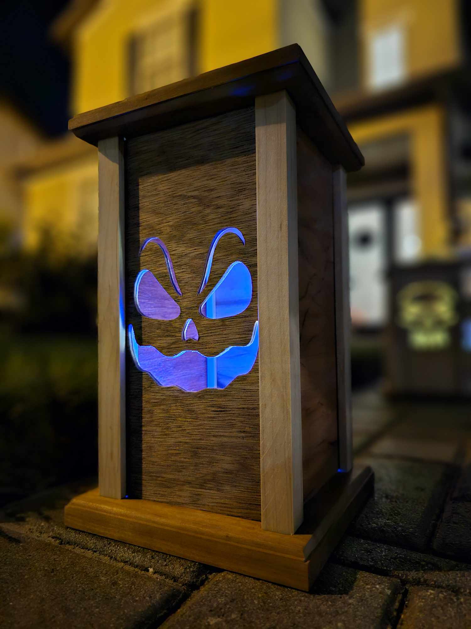 Wooden lantern face showing sinister smiling ghost.