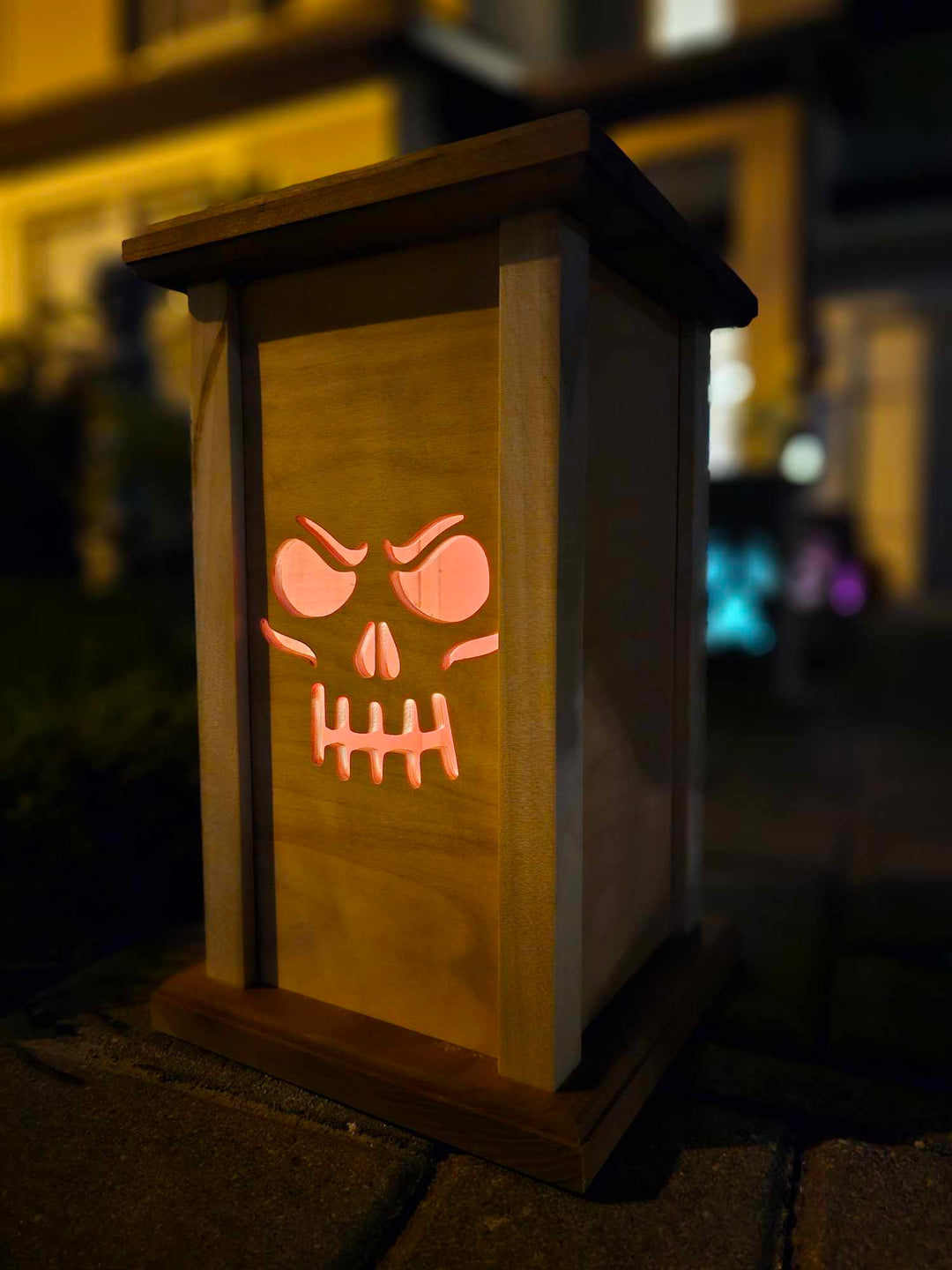 Wooden Lantern face depicting a grinning skull face.