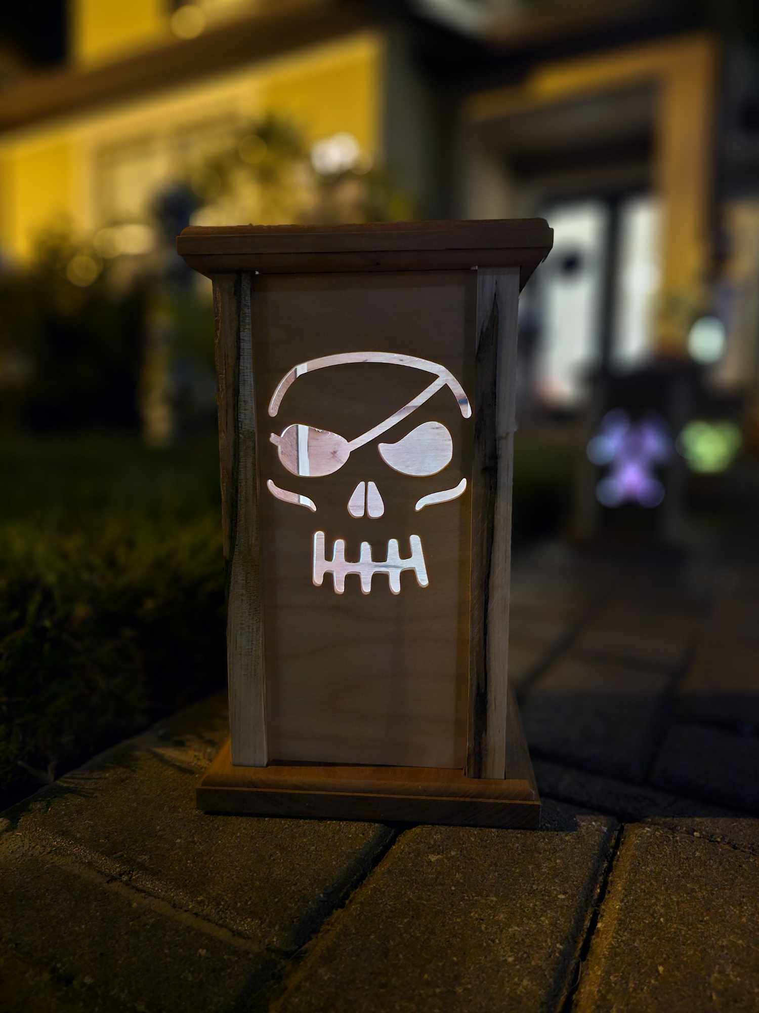 Wooden Lantern face depicting a pirate skull.