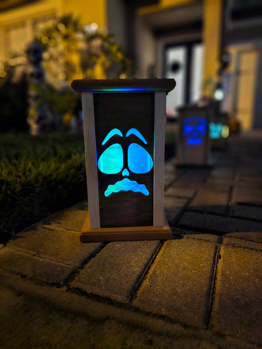 Wooden lantern face showing a scared ghost face.