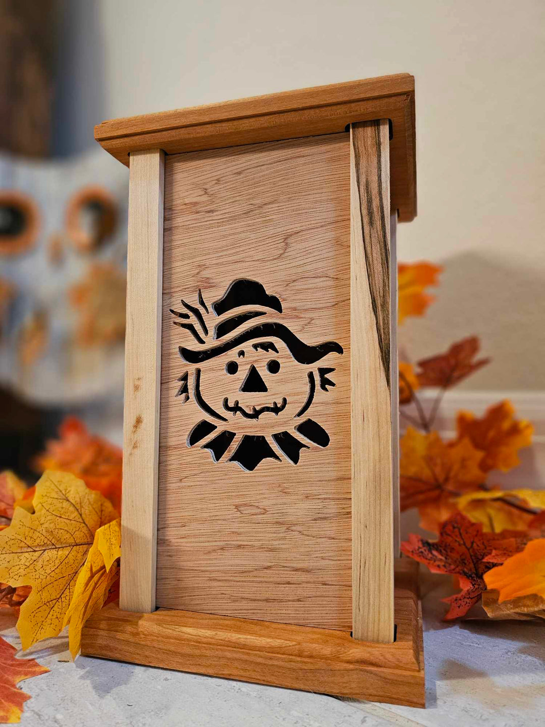 Wooden Lantern face showing a smiling scarecrow.