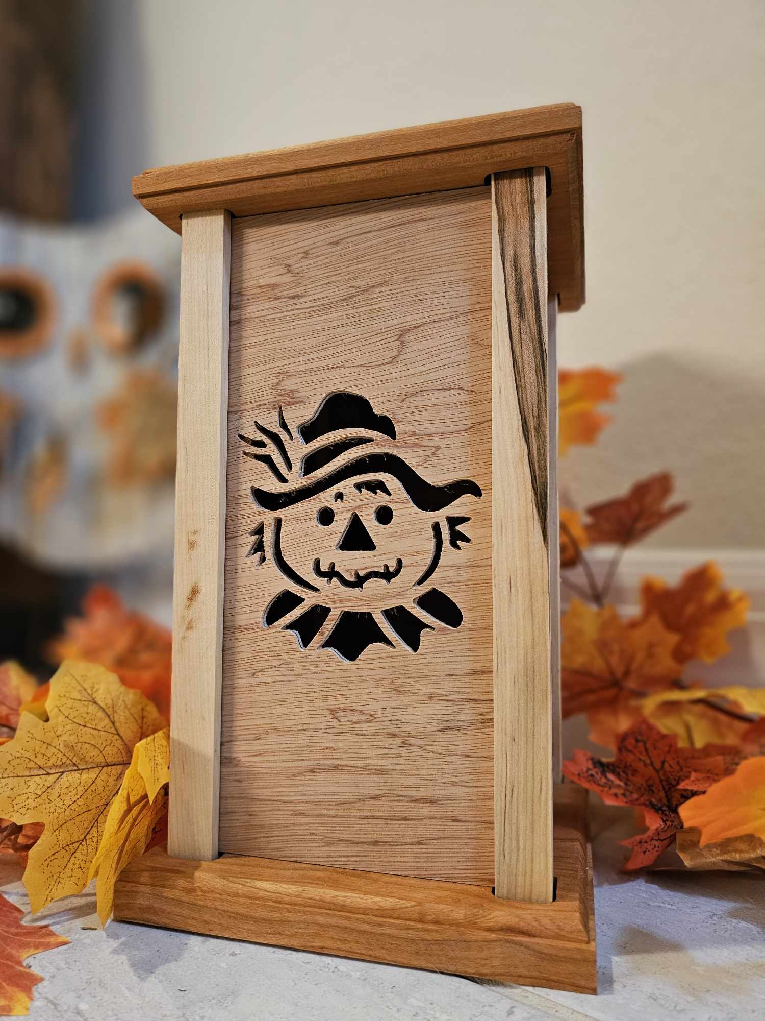 Wooden Lantern face showing a smiling scarecrow.