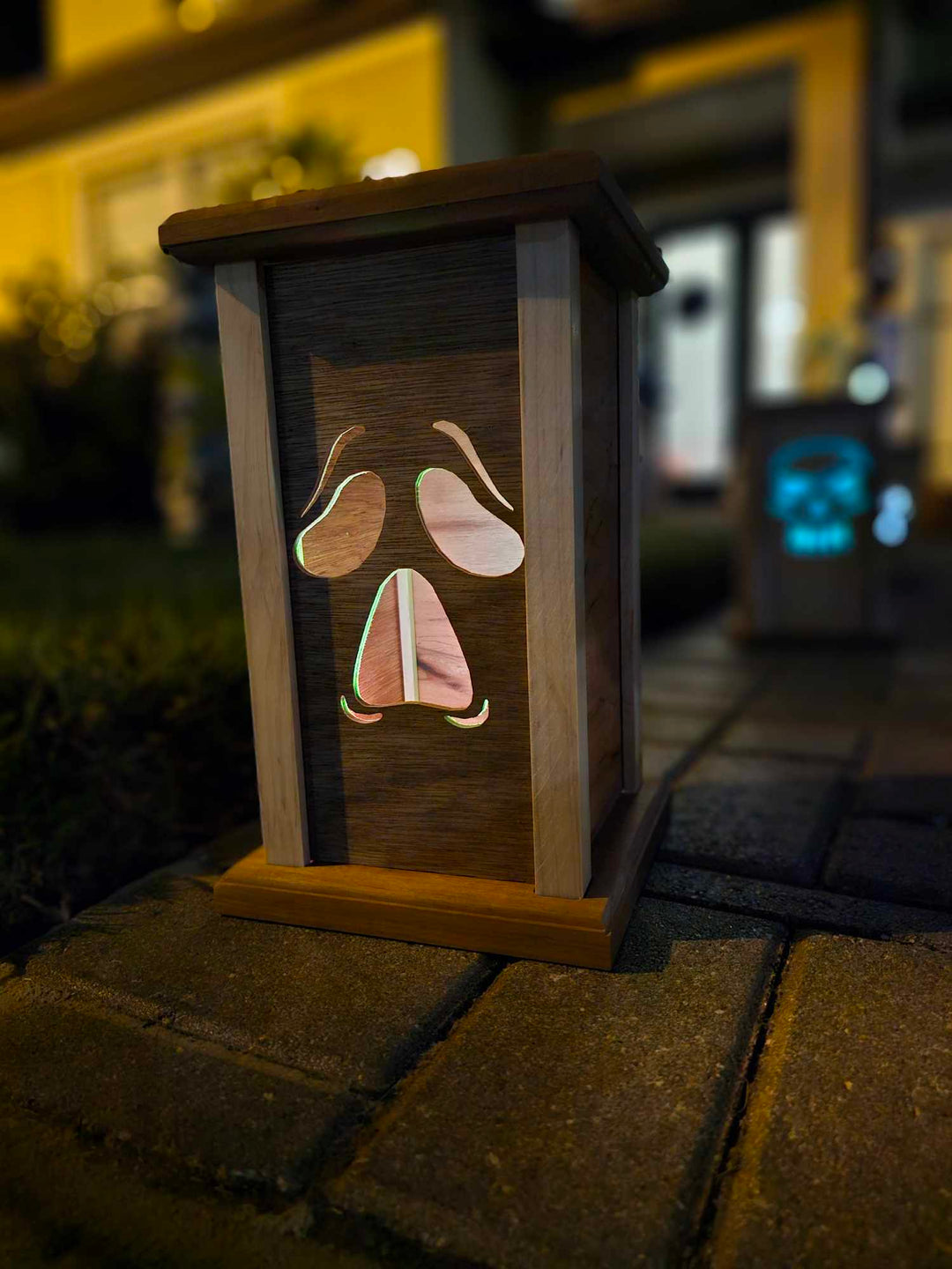 Wooden lantern face showing a moaning ghost face.