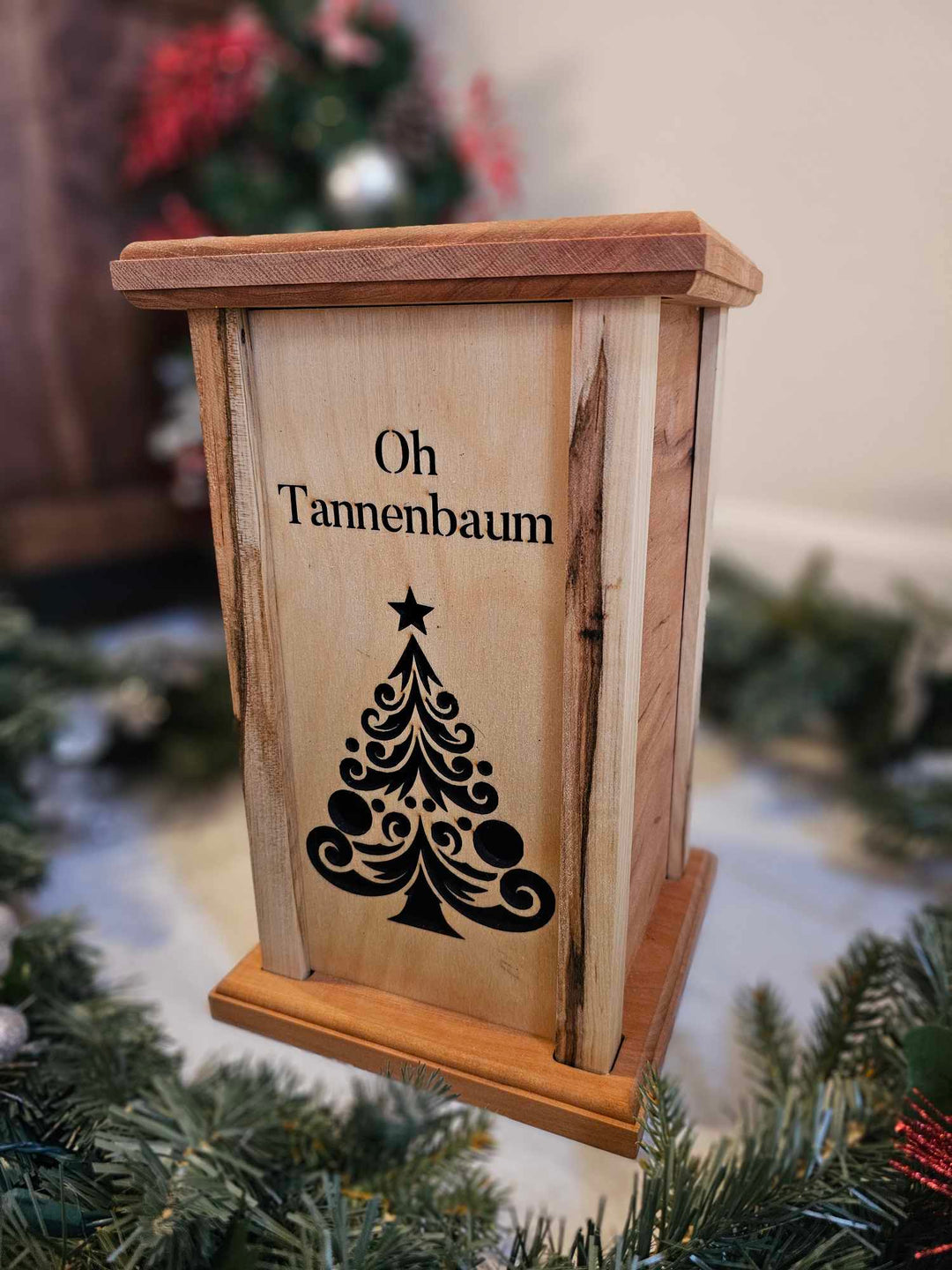 Wooden Lantern face showing a Christmas tree and the words Oh Tannenbaum.
