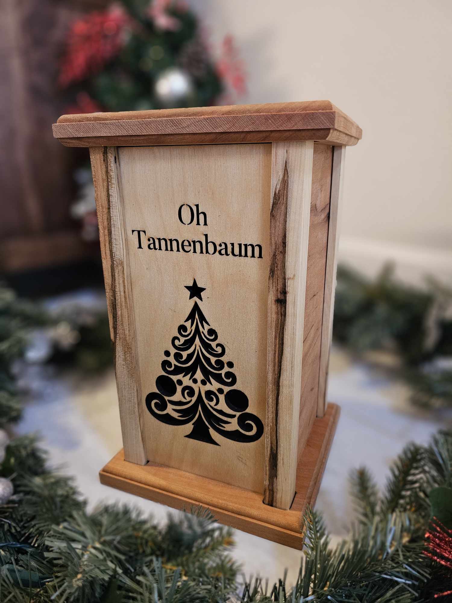 Wooden Lantern face showing a Christmas tree and the words Oh Tannenbaum.