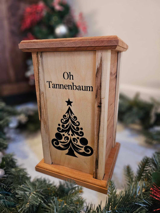 Wooden Lantern face showing a Christmas tree and the words Oh Tannenbaum.