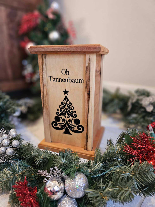 Wooden Lantern face showing a Christmas tree and the words Oh Tannenbaum.