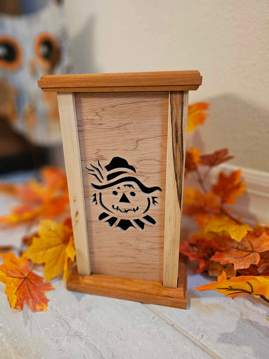 Wooden Lantern face showing a smiling scarecrow.