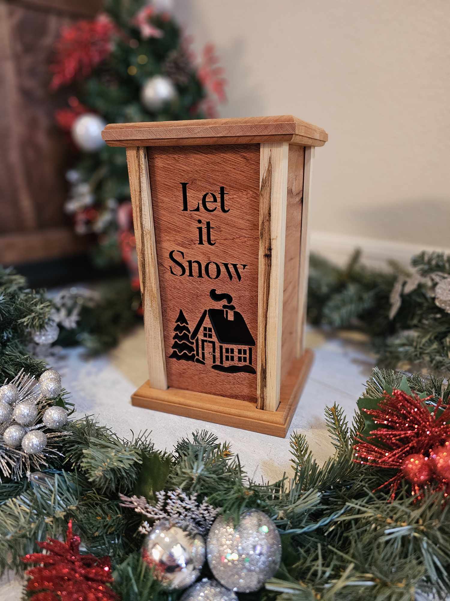 Wooden Lantern Face depicting a snowy cabin and tree with the words Let it Snow.