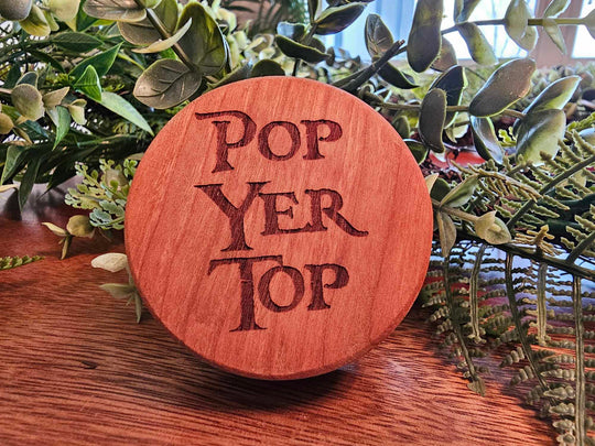 Wooden Puck-Style bottle opener with the words Pop Yer Top.
