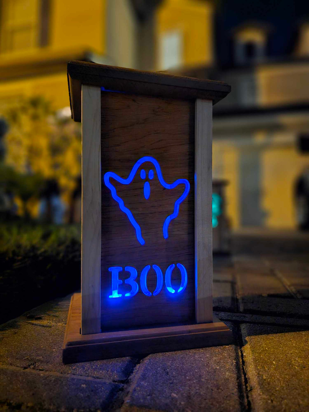 Wooden lantern face with a ghost and the words boo.