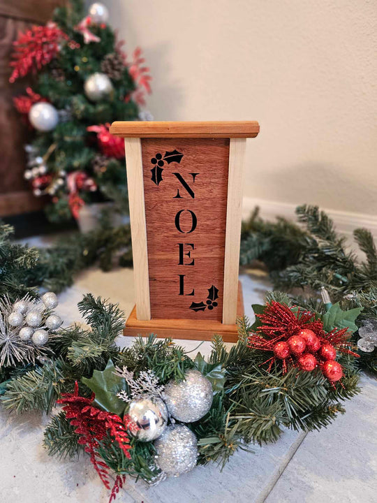 Wooden Lantern face with holly and the word Noel.