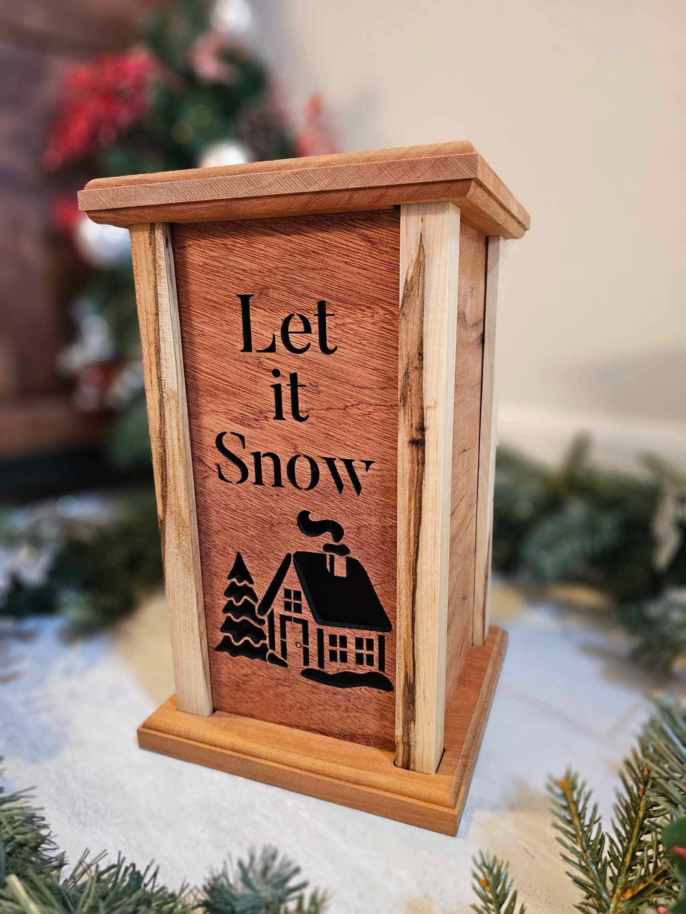 Wooden Lantern Face depicting a snowy cabin and tree with the words Let it Snow.
