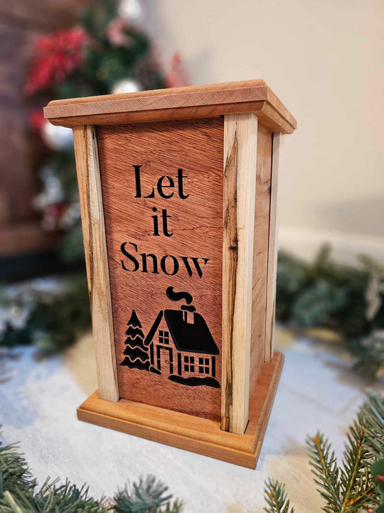 Wooden Lantern Face depicting a snowy cabin and tree with the words Let it Snow.