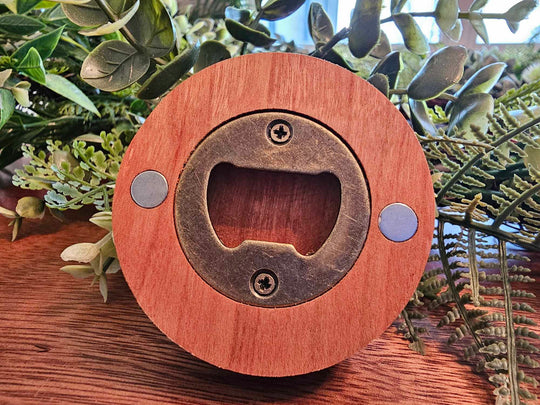Back of wooden puck-style bottle opener showing magnets and metal bottle opener.