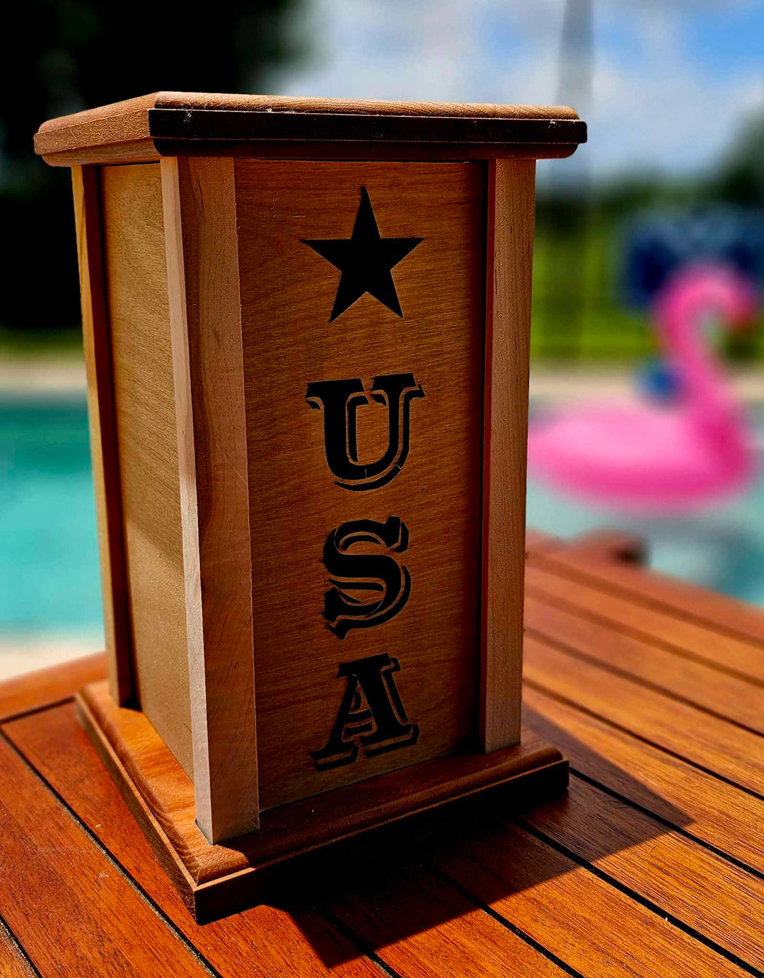 Wooden lantern face with the letters USA descending vertically, star positioned above letters.