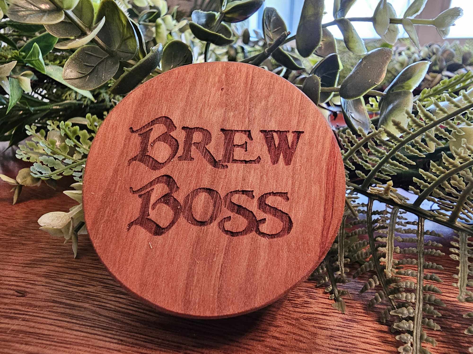 Wooden puck-style bottle opener with the words "Brew Boss".