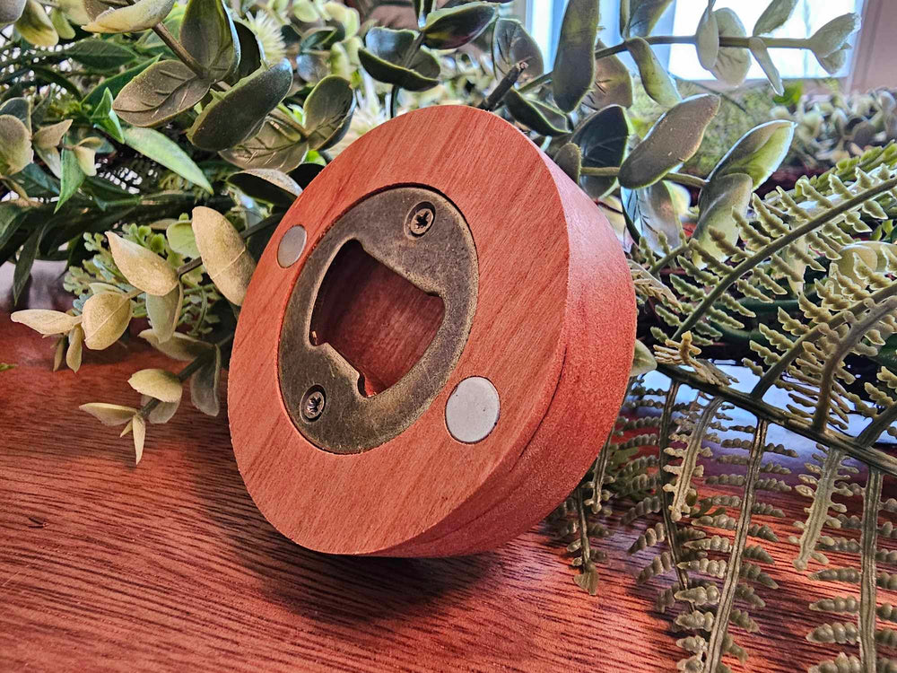 Back of wooden puck style bottle opener showing a magnets and metal bottle opener.