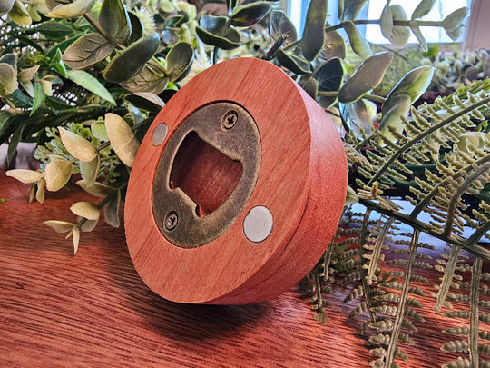 Back of wooden Puck-style bottle opener showing magnets and metal bottle opener.