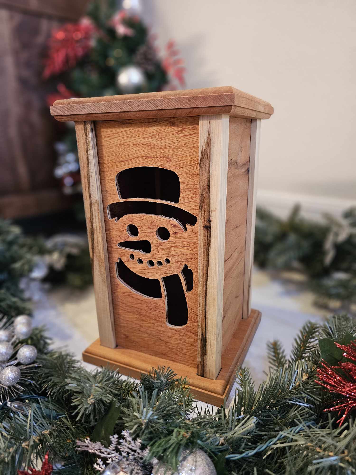 Wooden Lantern face depicting a snowman.