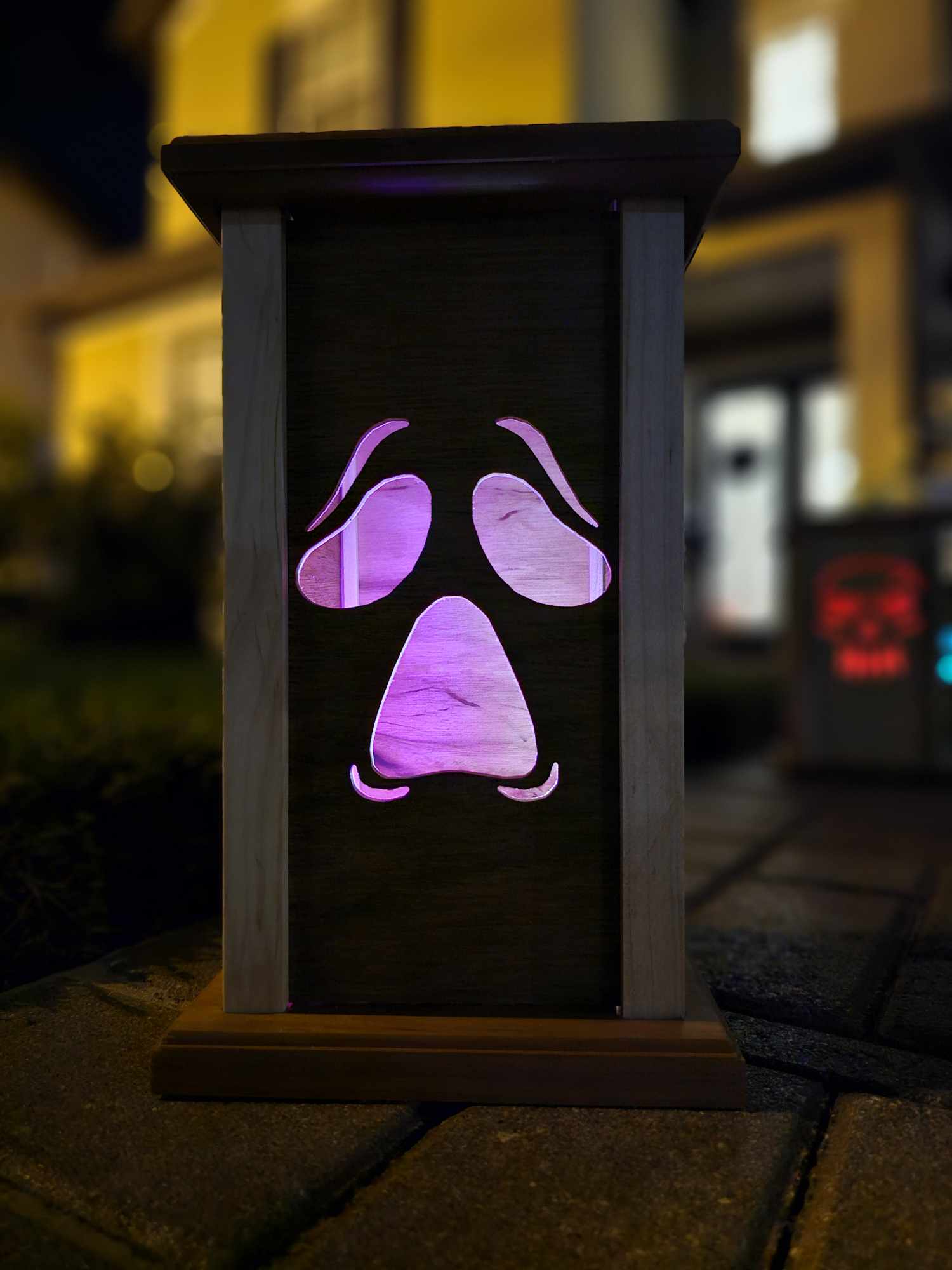 Wooden lantern face showing a moaning ghost face.