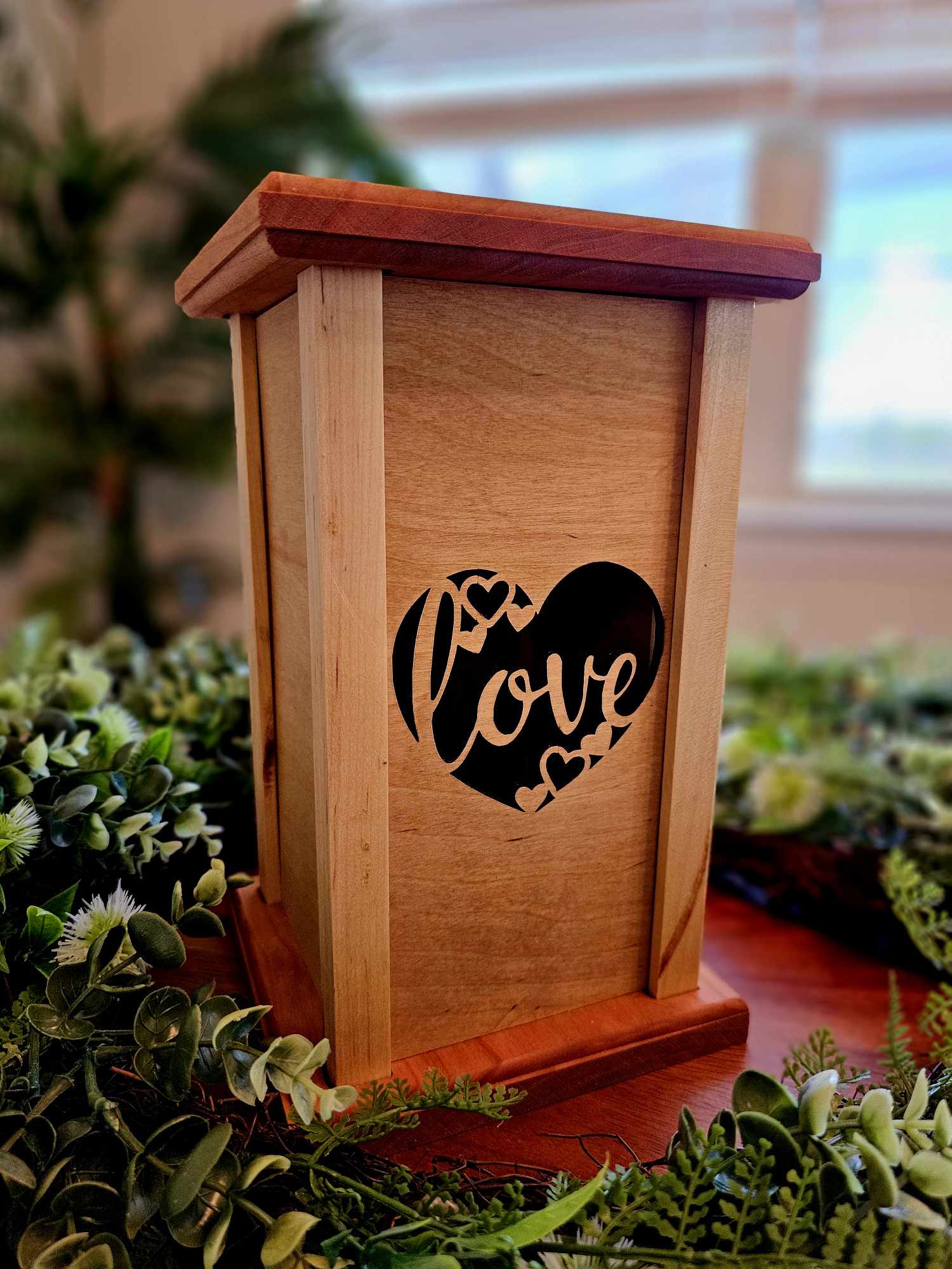 Wooden lantern face with a heart and the words love.