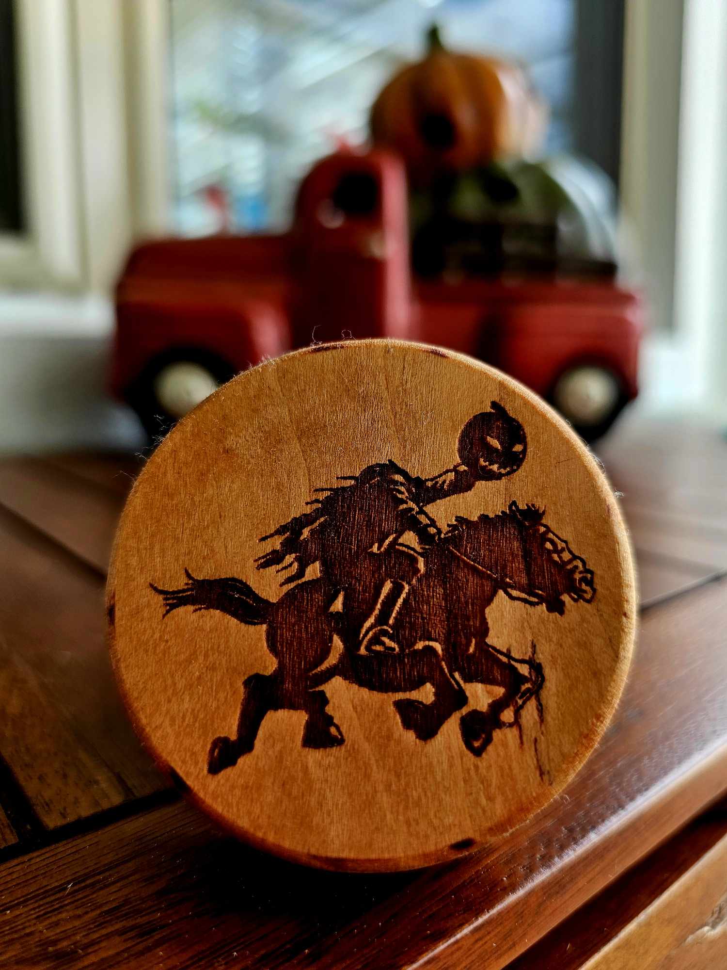 Wooden puck-style bottle opener depicting a headless horseman.