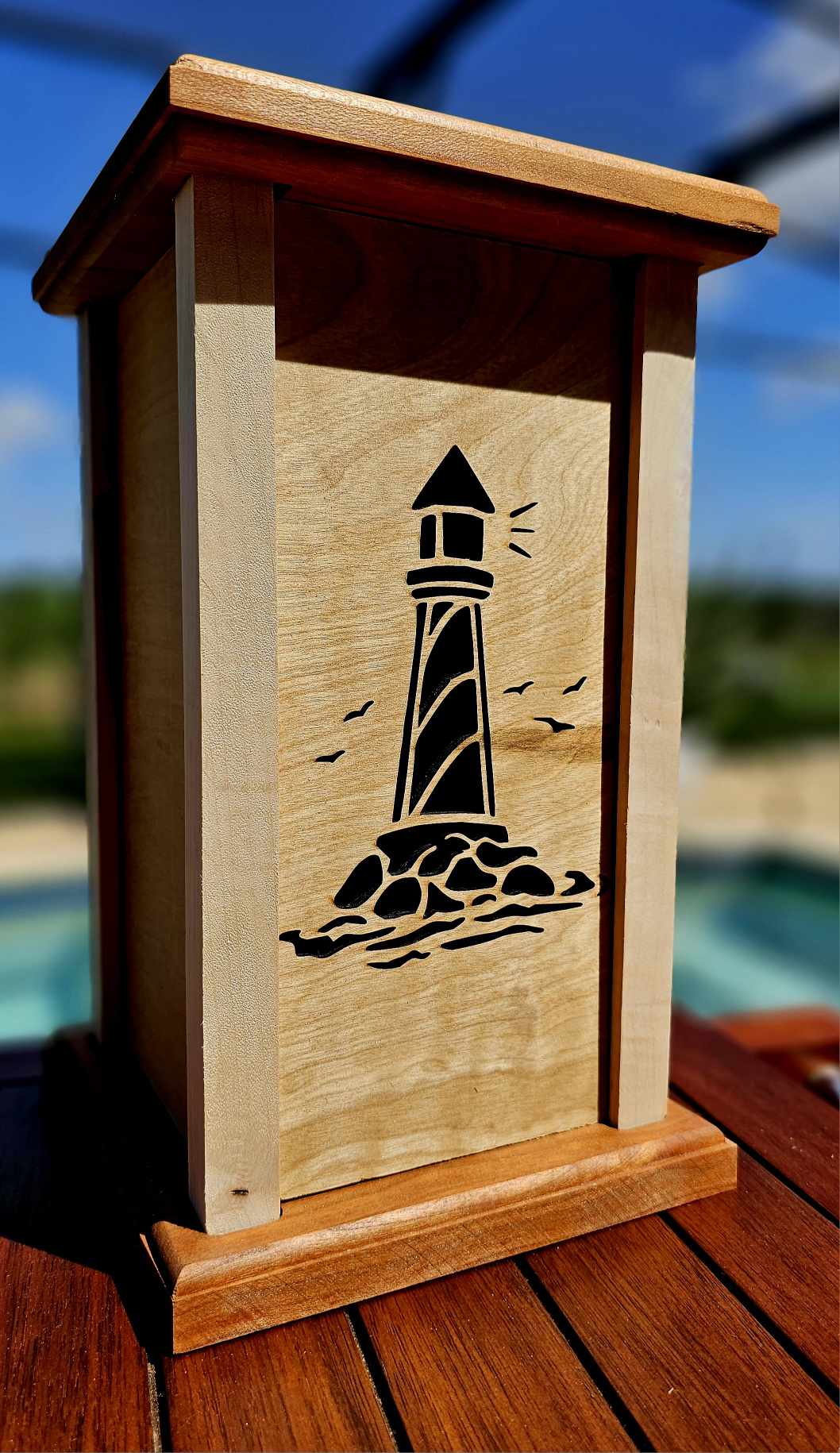 Wooden Lantern face showing a light house.