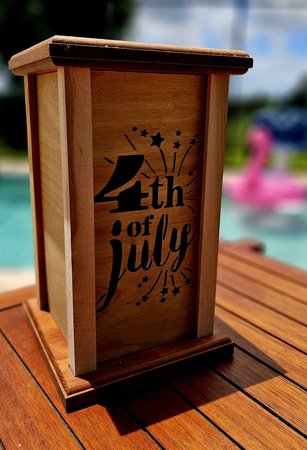 Wooden Lantern face showing fireworks and the words 4th of July.