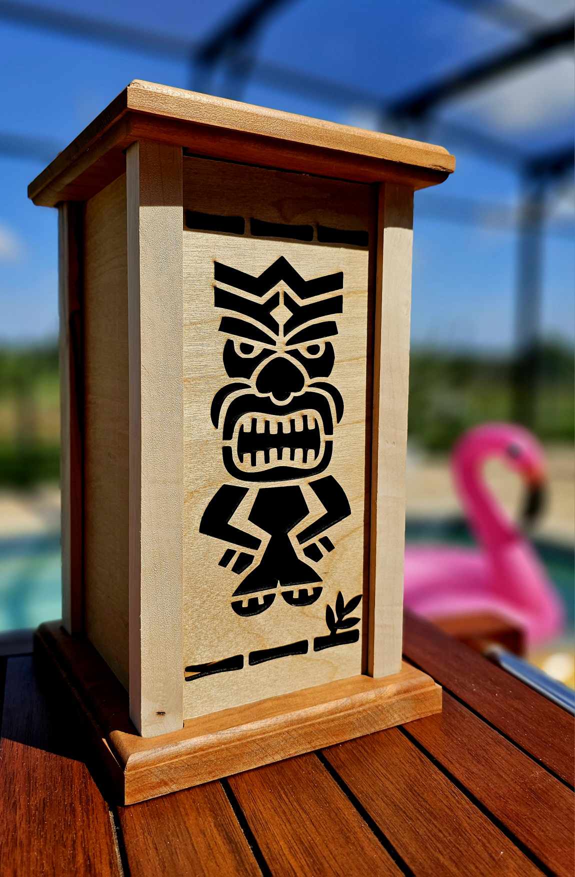 Wooden lantern face depicting a smiling tiki man totem.